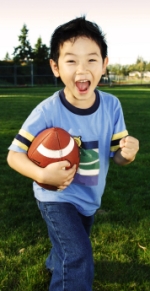 Elementary Boy Student Playing Football